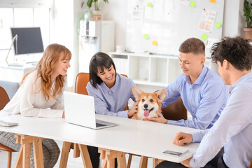 Wall Mural - Business people with Corgi dog sitting at table in office