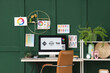 © Pixel-Shot - Graphic designer's workplace with computer monitor and color palettes in office