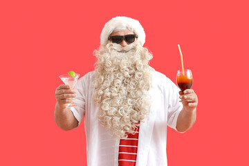 Sticker - Santa Claus with cocktails on red background. Christmas in July