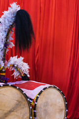 Wall Mural - Dhak is a special drum or musical instrument played during durga puja festival. dhaks are kept together against red background.