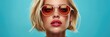 © Olena - Model Luxury. Portrait of a Stylish Blonde Woman with Goggles in Vogue Isolated Background