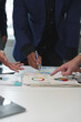 © crizzystudio - Business teamwork discussing brainstorming and calculating with a calculator on evaluation data in the conference room Focus on business growth and point out financial accounting charts.