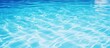 © Ilgun - Blue swimming pool surface with water background featuring copy space image
