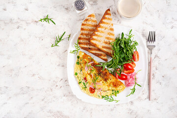 Wall Mural - Healthy breakfast. Omelette with cheese, tomatoes   and green herbs. Omelette, salad and toast. Keto, ketogenic lunch. Top view, above