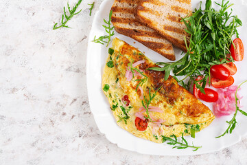 Wall Mural - Healthy breakfast. Omelette with cheese, tomatoes   and green herbs. Omelette, salad and toast. Keto, ketogenic lunch. Top view, above