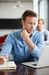 Man, book and laptop in modern office with thinking for information, planning design proposal and connection. Male programmer, coding language and research on computer for software development ideas