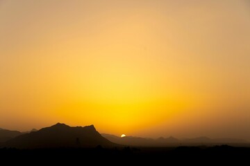 Wall Mural - Landscape of rocky mountains during a breathtaking sunset in the evening