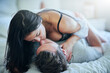 © peopleimages.com - Passion, affection and couple in bed with kiss, romance and morning bonding in apartment. Relationship, man and woman in bedroom with intimate embrace, love and relax with care on weekend in home