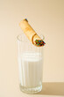 © ADDICTIVE STOCK - Waffle roll with sprinkles leaning on a glass of milk