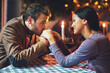 © peopleimages.com - Couple, kiss and hands with romance on date in restaurant for anniversary, honeymoon and love with candle. People, happy and dinner with fine dining for support, trust and commitment in marriage