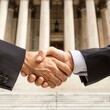 © authapol - A lawyer shaking hands with a client outside a courthouse, symbolizing a successful outcome or agreement reached in their case