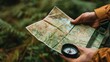 © chanidapa - A close-up of a map and compass in a hiker's hand, planning the next part of the journey surrounded by nature.