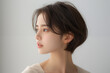 © wazamai - Close-up portrait of a young Asian woman with a thoughtful expression