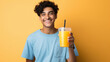 © Niks Ads - young Indian man holding orange juice glass