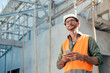 © Have a nice day  - Caucasian Male technician engineer construction worker working in building site wearing safety vest and helmet gears, using mobile smartphone technology with digital blueprint analyzing planning.