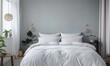 © atikun - White duvet cover and two pillows on the bed. The duvet cover is made of 100% cotton percale and has a sateen weave. The pillows are made of 100% cotton sateen.