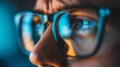 © Lull - Focused reflection on eyeglasses. A close-up shot of a person's face reflecting light off their eyeglasses, highlighting intense focus.