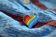 © Picasso - Illustration of  rainbow heart shaped enamel pin resting on a blue shirt