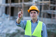© Have a nice day  - Male caucasian technician engineer construction pointing gesture worker using computer laptop for digital blueprint innovation analyzing planning building, wearing safety vest and helmet gears.