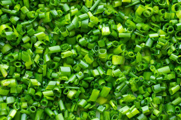 Top view of thinly chopped chives as a food background texture.