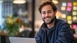 © Studio Nova - Smiling man with a laptop