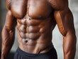 © Rona_65 - Close-up of a muscular man's torso with defined abs and arms, displaying physical fitness and strength.