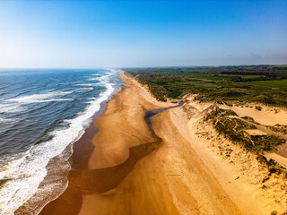 Wall Mural - balmedie beach from the air. small estuary finds the sea on very long straight beach with high grass