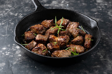 Wall Mural - Garlic butter beef steak bites in iron cast pan