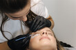 © Aleksandr - Beautician making eyelash lamination procedures for young model. Modern eyelash care procedures laminating and extension for lashes. Professional beauty studio