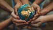© Mars0hod - Earth Day Concept, Hands of diverse people holding a small globe together