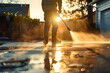 © john - Man power washing concrete driveway with electric pressure washer in sunny suburban morning. Concept Home Maintenance, Pressure Washing, Driveway Cleaning, Outdoor Chores, Morning Routine AI