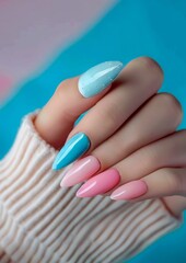 Wall Mural - A woman holding a pair of pink and blue nails.