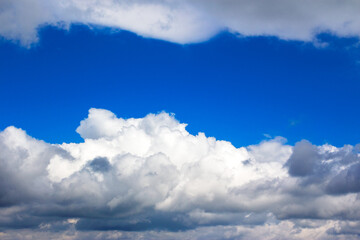 Wall Mural - grey clouds on a blue sky. calm nature background. weather change before the rain