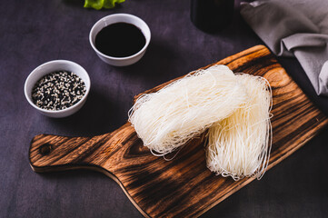 Poster - Two servings of funchose dry rice noodles on a board on the table