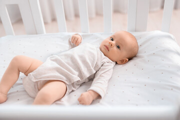 Canvas Print - Cute little baby lying in crib at home