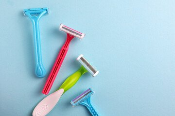 Wall Mural - razors for removing unwanted body hair on a bright background. Home hair removal method