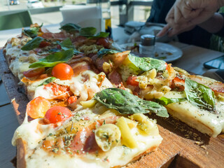 Pizza served in a bar on a board