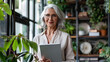 © kanesuan - Senior female entrepreneur using a tablet to manage business operations