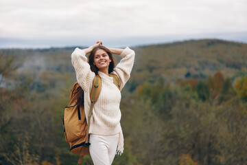 Poster - Smiling Woman Embracing Mountain Adventure: A Stylish Journey of Happiness and Freedom