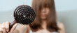 © Jo Panuwat D - Hair loss problem, Balding , Beauty treatments and health care concepts asian woman holding holding comb with hair loss, young female hold hairbrush and brushing with fall hair from scalp