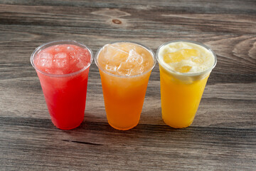 Wall Mural - A view of three cold aguas frescas, featuring watermelon, cantaloupe, and pineapple.