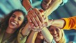 © VISUAL BACKGROUND - A group of people holding hands together.