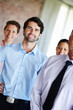© peopleimages.com - Team leader, happy and man with group in portrait for about us, partnership and pride in office. Businessmen, women and together with smile for internship, recruitment and new career in company