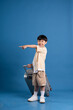 © Q88 - Portrait of asian boy posing on blue background