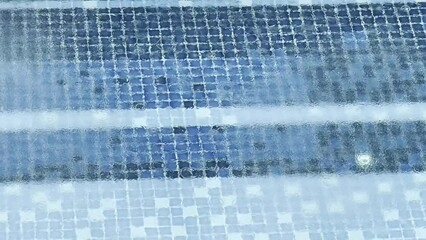 Blue abstract binary code pattern on a light background. It's like a digital pond with a square tile and a drizzle of rain.