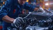 © Imron - Auto mechanic working on car broken engine in mechanics service or garage