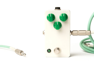 Blank guitar pedal with green knobs and jacks