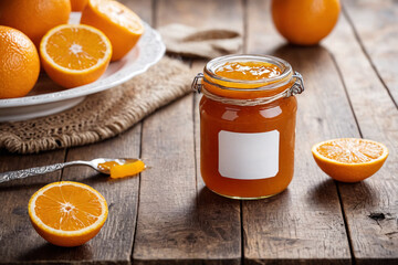 Sticker - Sweet dessert made of fresh fruits, a jar of orange jam, Homemade orange jam, citrus fruit marmalade, homemade autumn preparations.