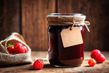 Sticker - Wooden background with raspberry jam and berry. Mockup of a jar of raspberry jam with a tag. Homemade jam with raspberry on the wooden table, selective focus.