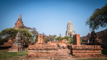 Wall Mural - Ruins of the Chedi Stupa Church And an ancient Buddha image from the Ayutthaya period is in Wat Ratchaburana, an old temple over six hundred years old, Ayutthaya, Thailand.